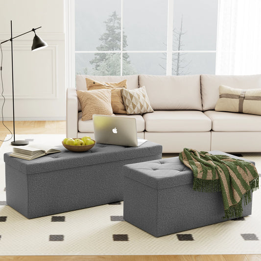 Living room with a beige sectional sofa, gray ottomans, and a laptop on a coffee table.